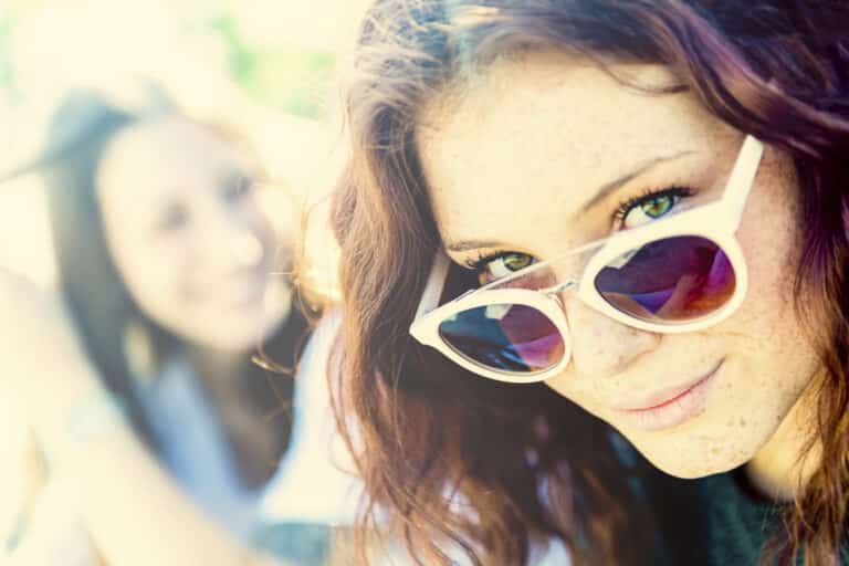 Woman looking over her sunglasses